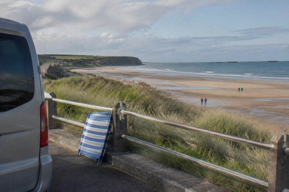 A shared minibus parked beside the esplanade above Omaha Beach