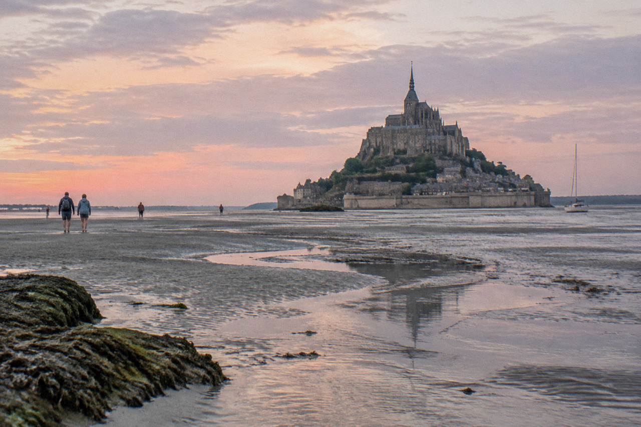 The abbey of Mont-Saint-Michel rising above the tidal flats at low tide