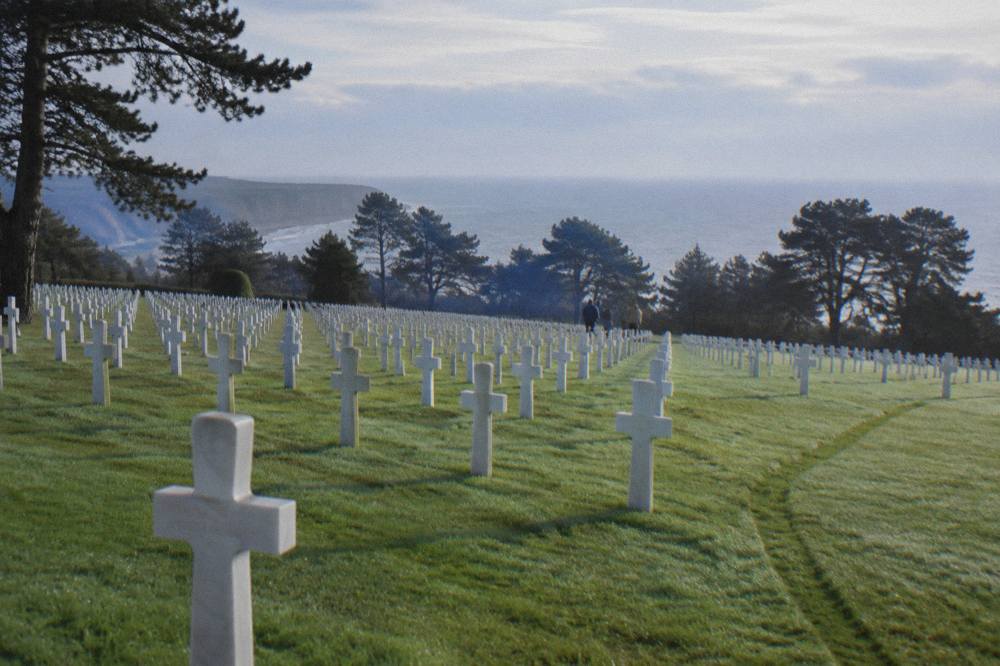 Rows of white crosses in the American Cemetery above the Normandy coastline