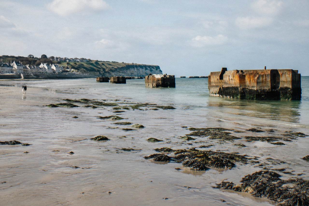 Concrete harbour caissons standing in the sea off Arromanches at low tide
