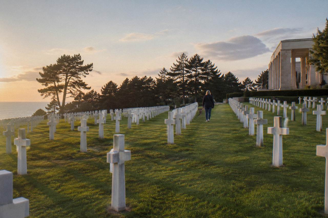 Rows of white marble headstones in the Normandy American Cemetery above Omaha Beach