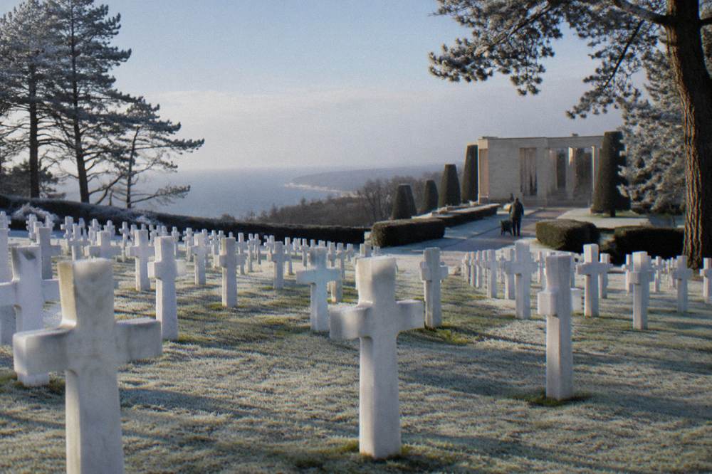 Rows of white crosses in an American military cemetery above the Normandy coast