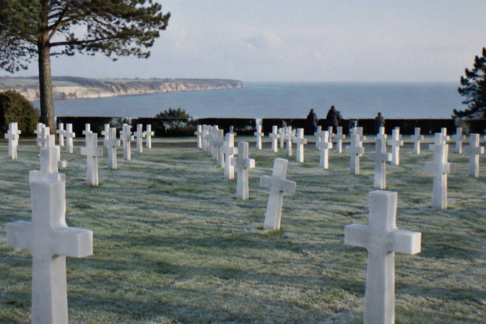 Rows of white crosses in the Normandy American Cemetery stretching toward the sea