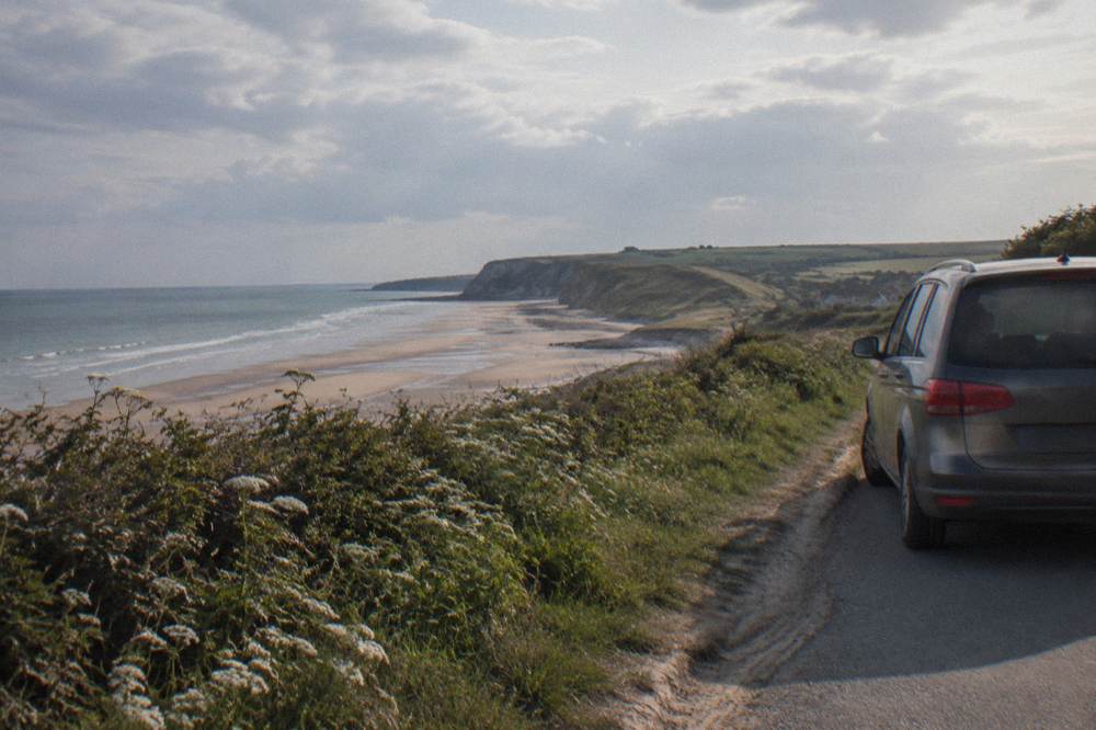 A minivan parked on a small road above the Normandy landing beaches