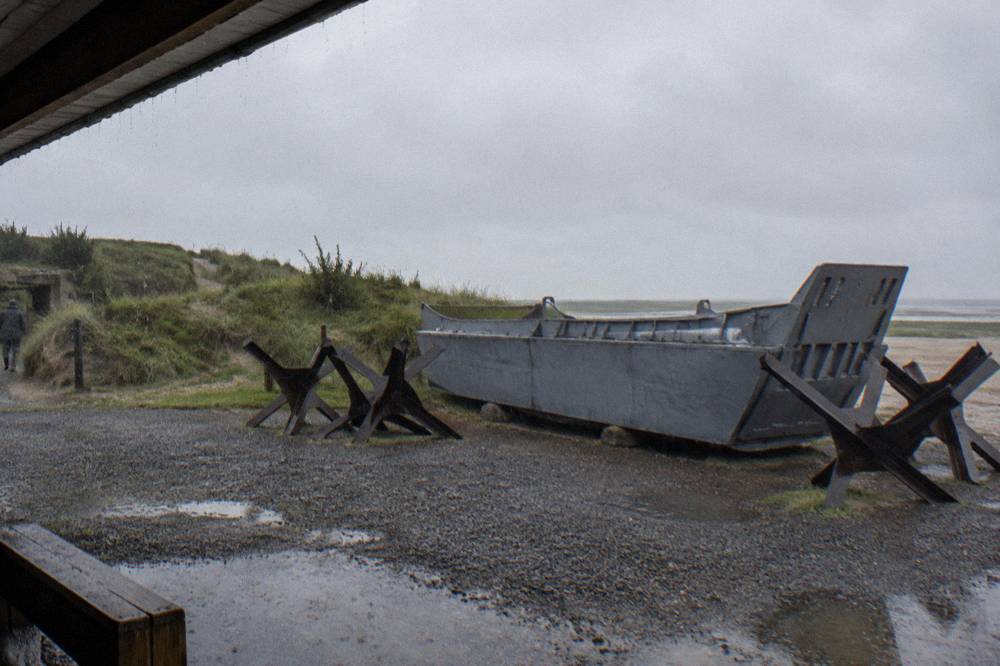 Landing craft and beach defenses preserved at a D-Day museum on the Normandy coast