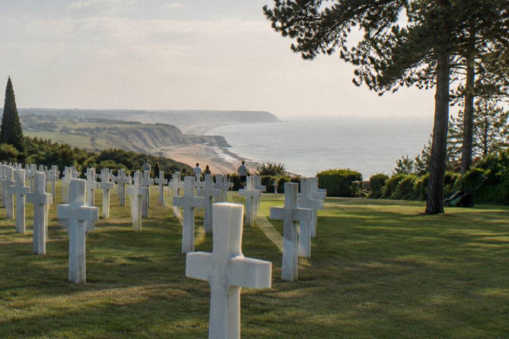 Rows of white crosses in an American military cemetery above the sea