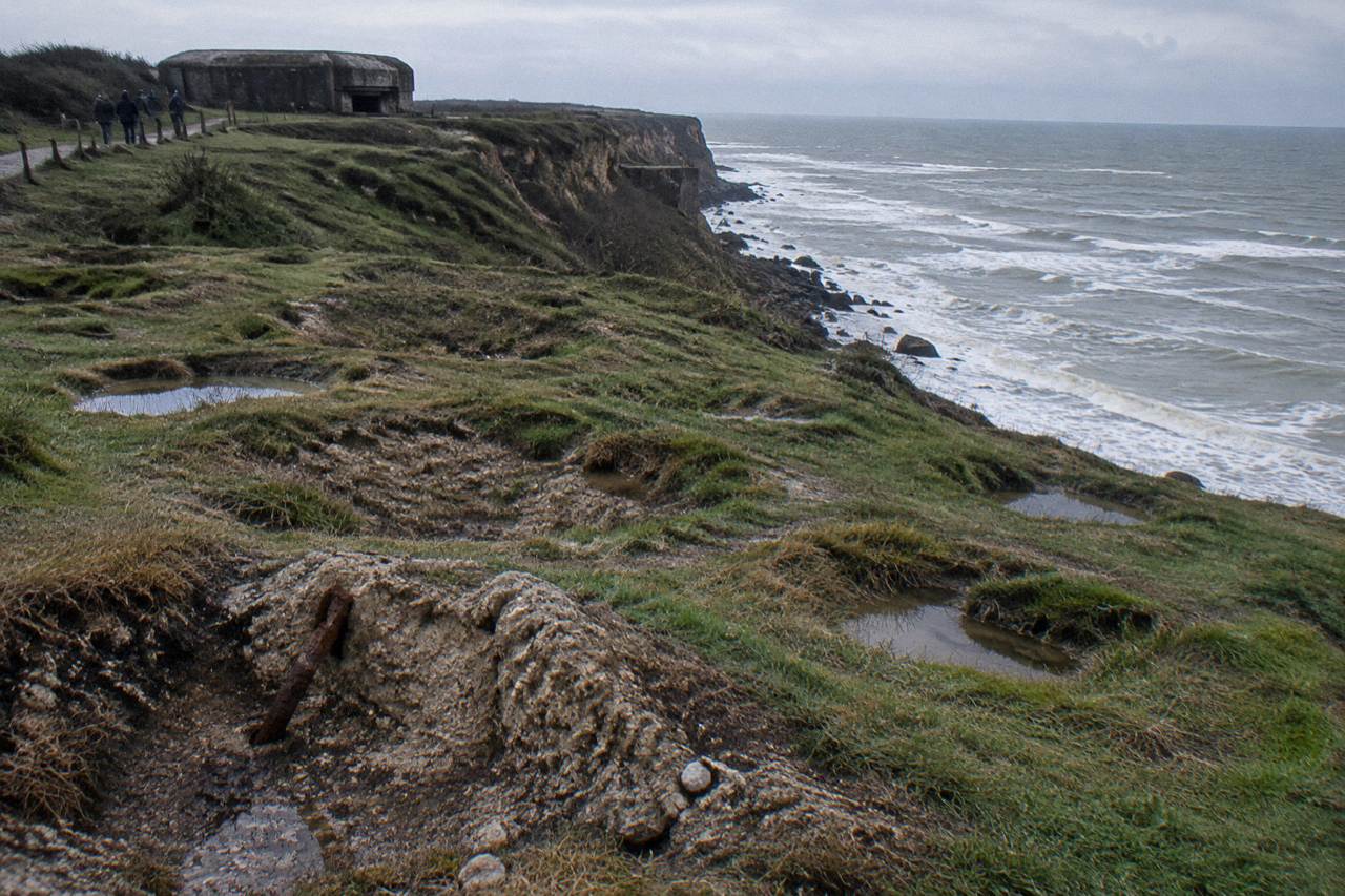 Wartime bunkers on a grassy clifftop above the Normandy coastline
