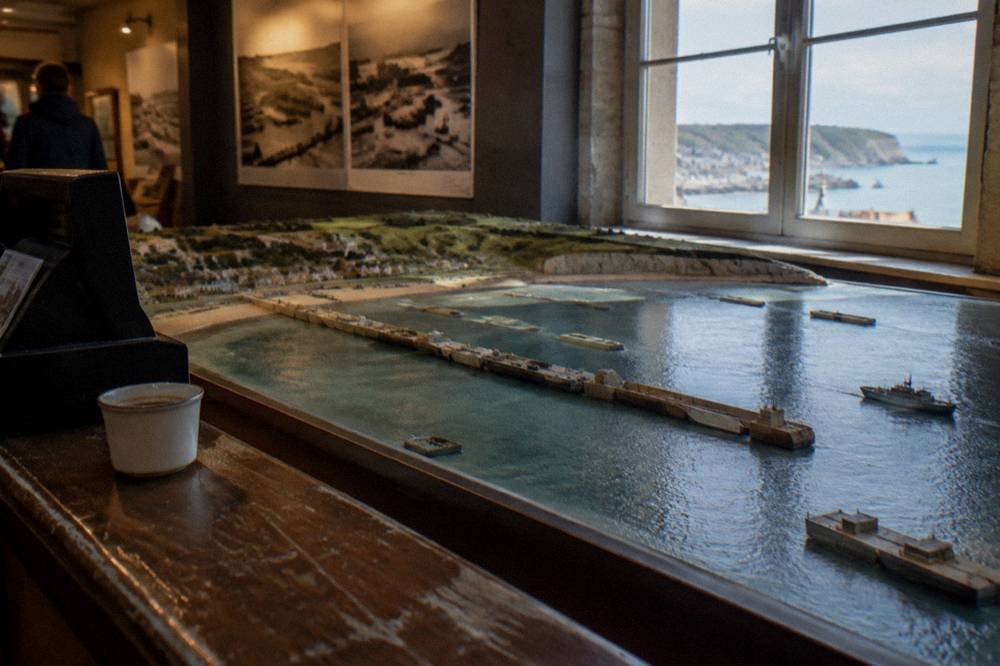 Ticket counter and model of the Mulberry harbour inside the Arromanches landing museum