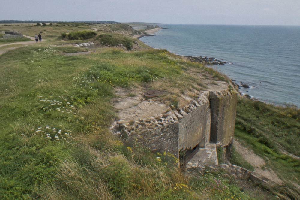 Concrete gun casemate on the clifftop at Pointe du Hoc surrounded by grass