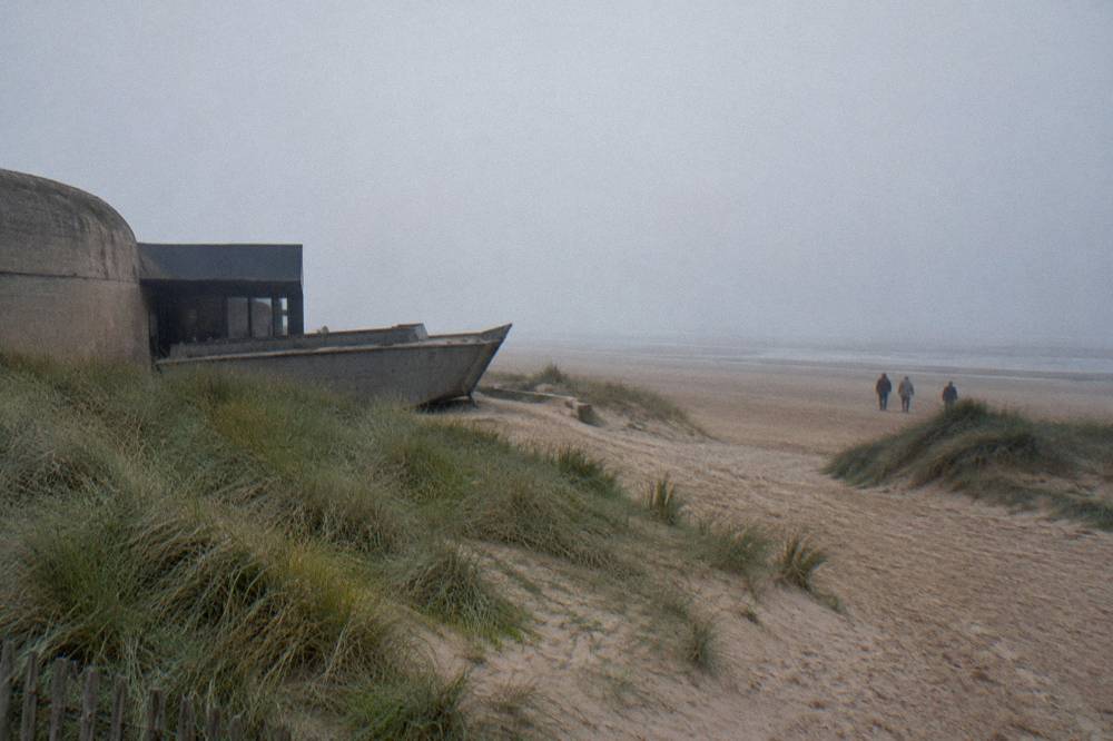 Smooth sandy expanse of Utah Beach with dune grass and empty horizon