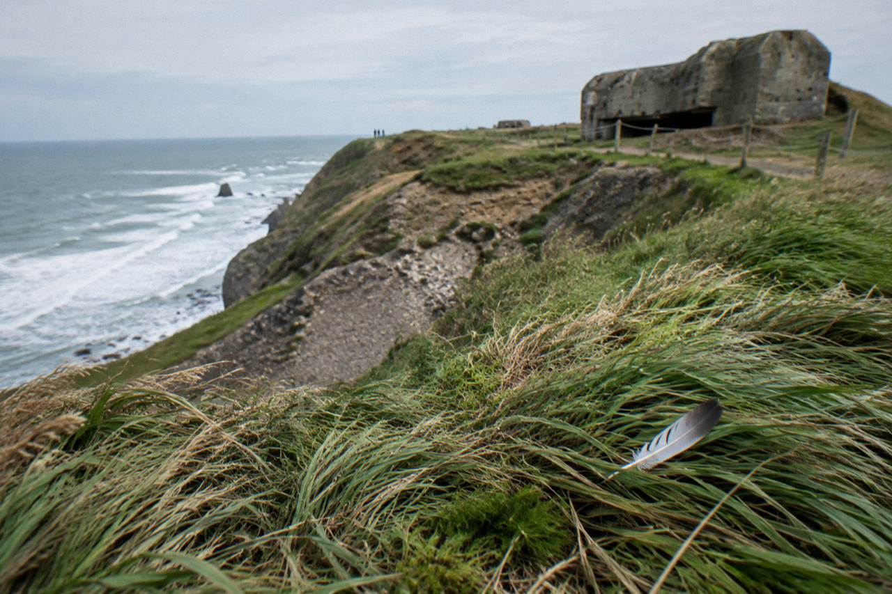 Clifftop promontory at Pointe du Hoc with wind-bent grass above the sea