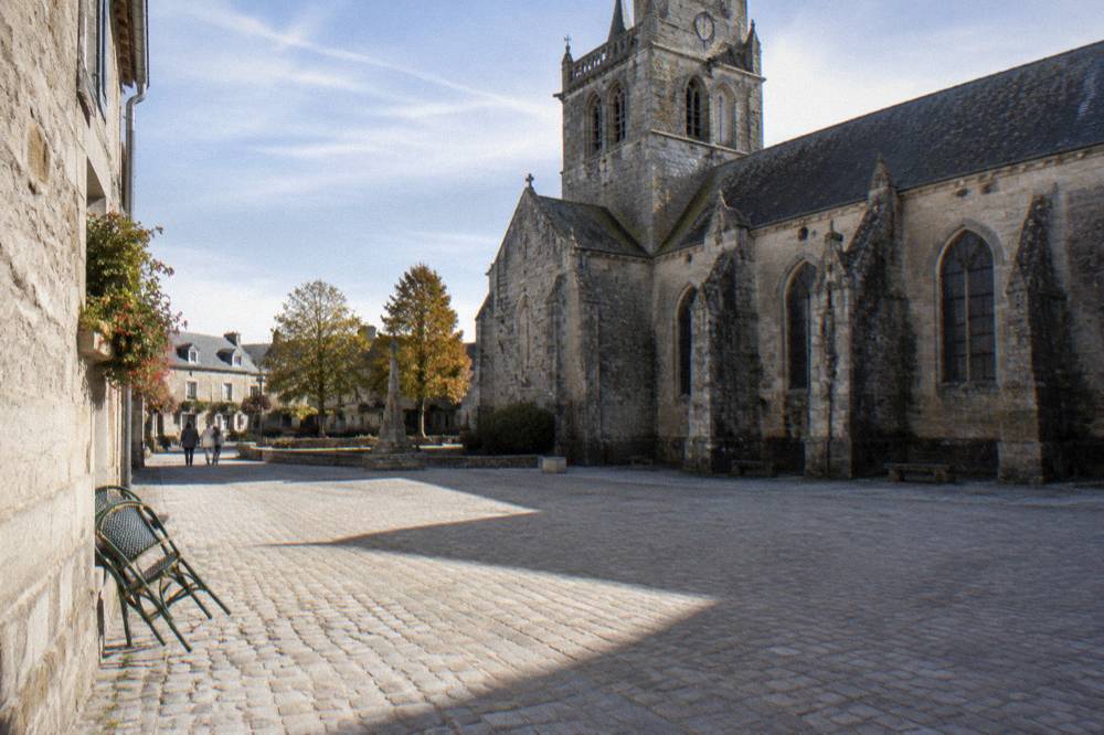 A stone church and quiet square in a small Normandy village near the airborne drop zones