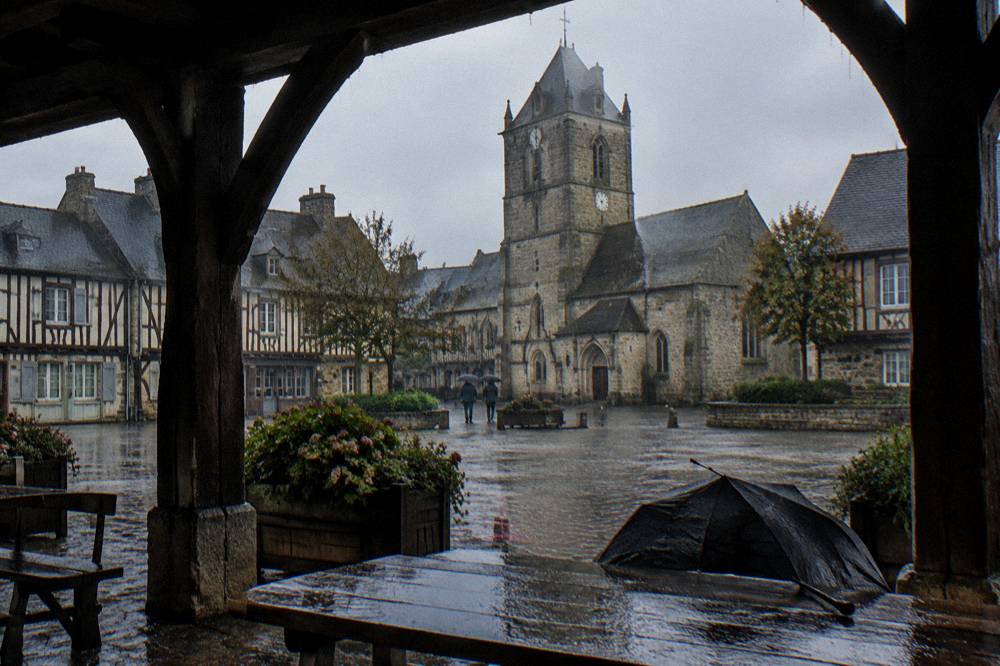 Market square with half-timbered and stone buildings around a church tower