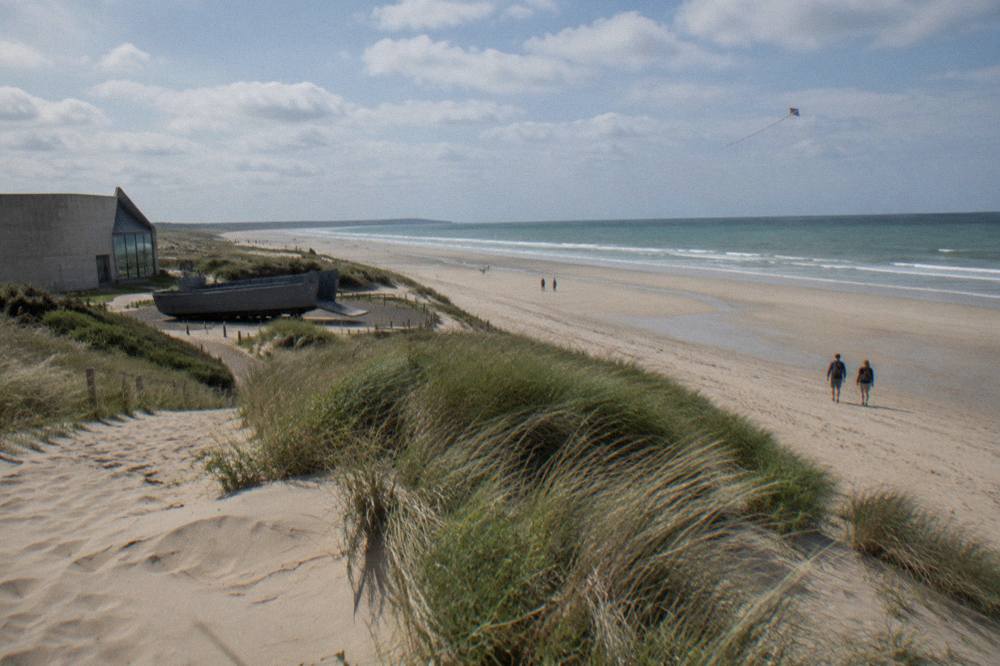 View across Utah Beach sand toward the sea with the low dune line on the right